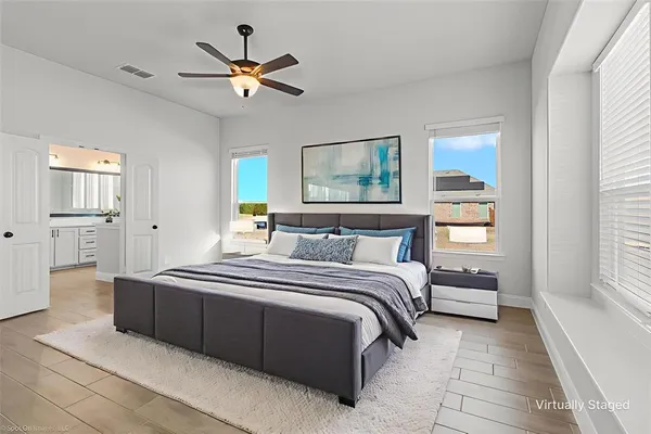 a spacious bedroom with a bed and window