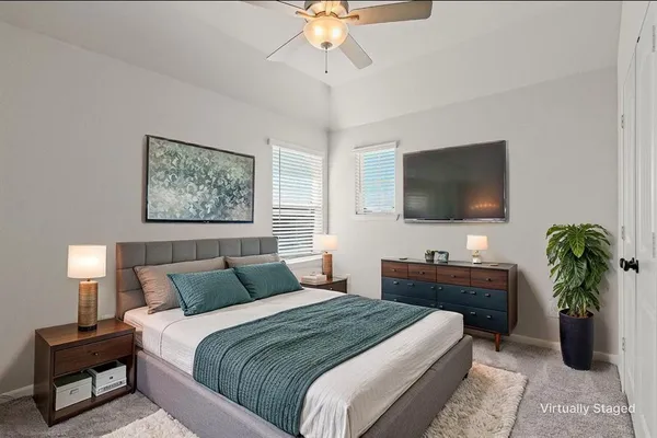 a bedroom with a bed and a flat screen television