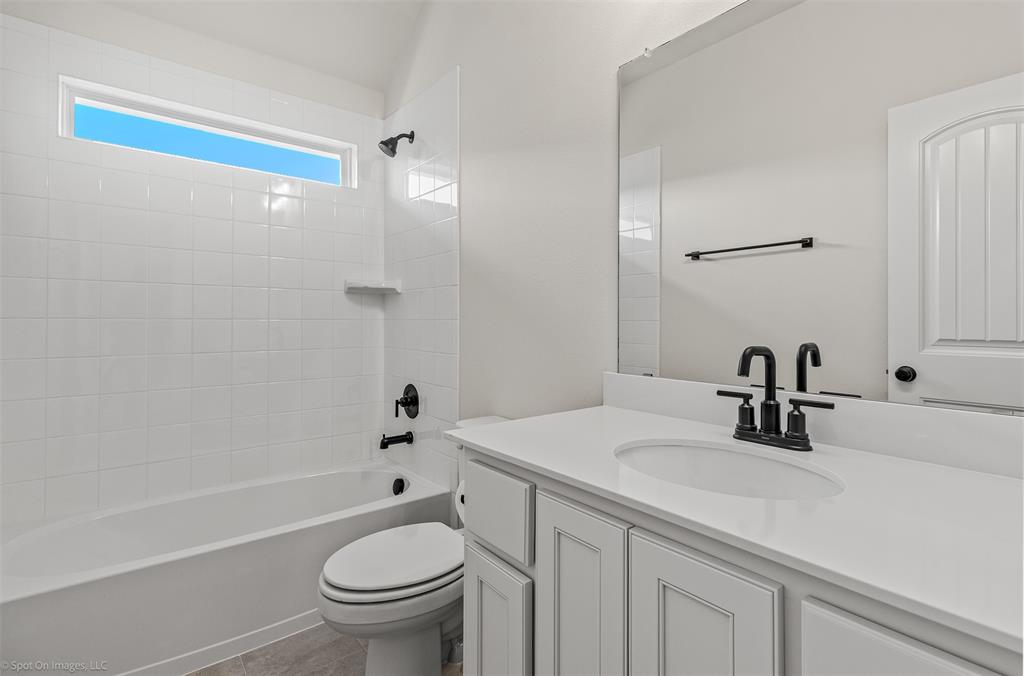 1213 Haggetts Pond Road Forney, TX 75126 - Photo 23 of 30 a bathroom with a sink a toilet and shower