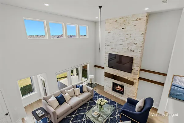 a living room with furniture a flat screen tv and a fireplace