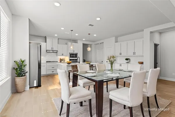 a view of a dining room with furniture and a kitchen