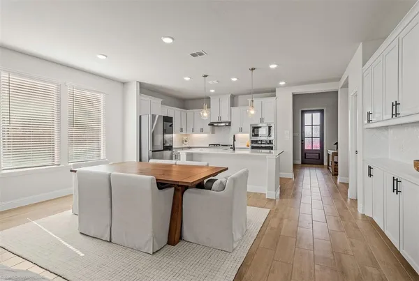 a kitchen with stainless steel appliances granite countertop a sink a stove and a refrigerator