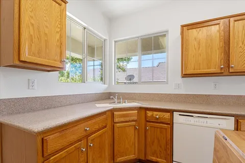 a kitchen with stainless steel appliances granite countertop a sink and a cabinets