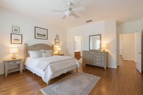 a bedroom with a bed and wooden floor
