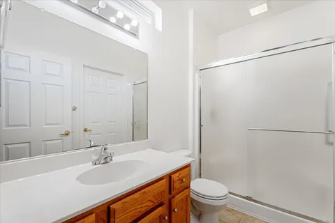 a bathroom with a sink toilet a mirror and shower