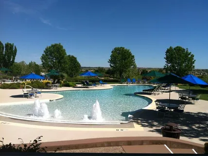 a view of a swimming pool and lounge chairs