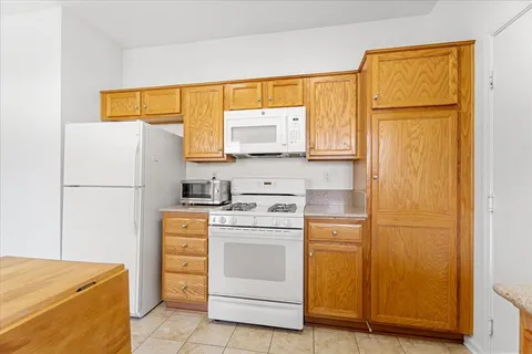 a kitchen with a stove a refrigerator and a sink