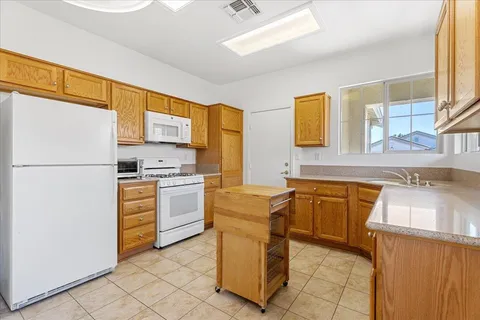 a kitchen with stainless steel appliances granite countertop a refrigerator sink and stove