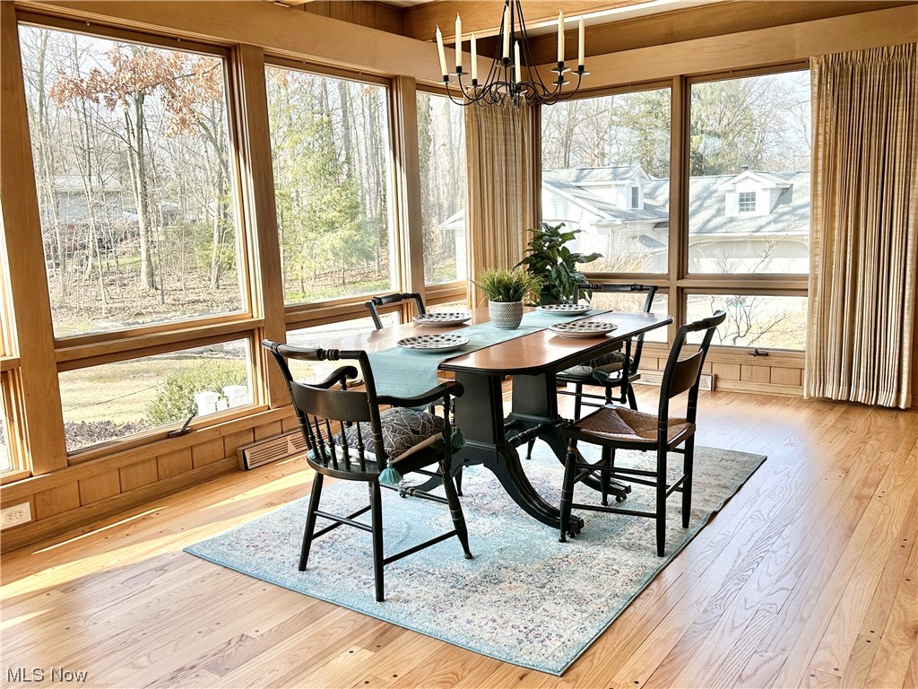 6130 Renninger Road New Franklin, OH 44319 - Photo 7 of 30 Dining area with wall of windows with an inviting chandelier and plenty of natural light