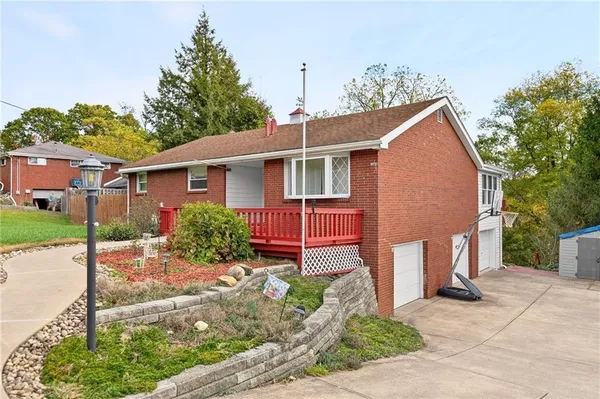a view of a house with a yard and potted plants