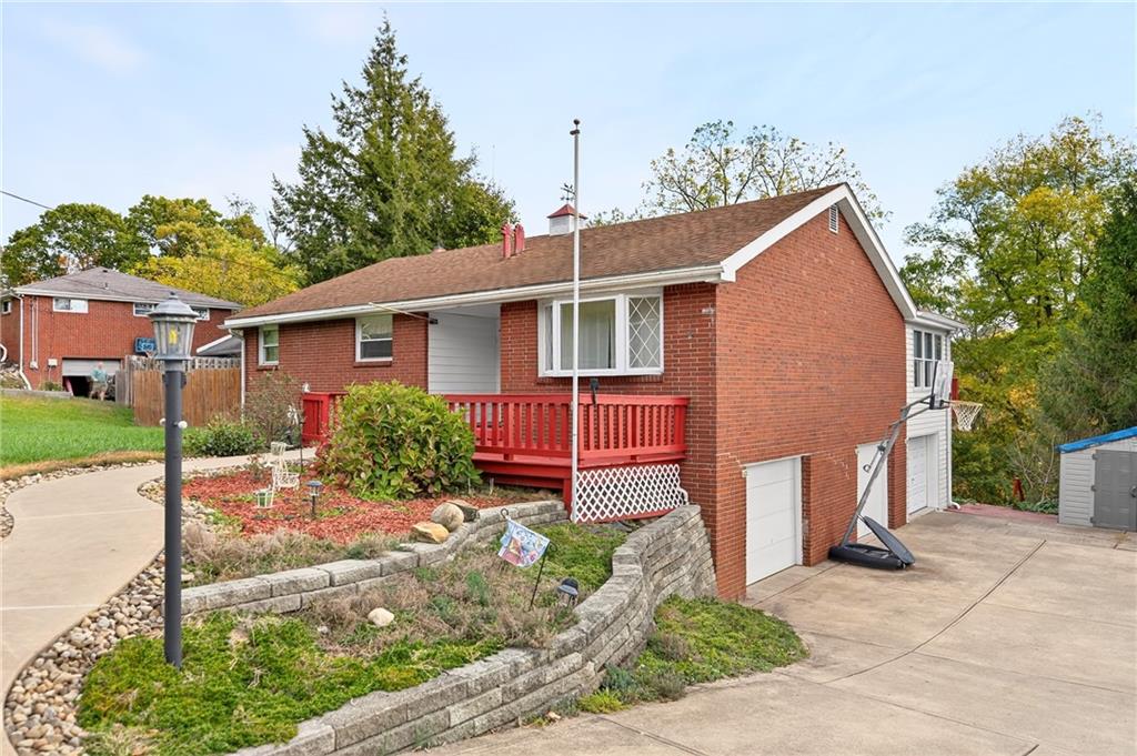 a view of a house with a yard and potted plants