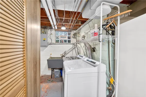 a view of storage and utility room with washer and dryer