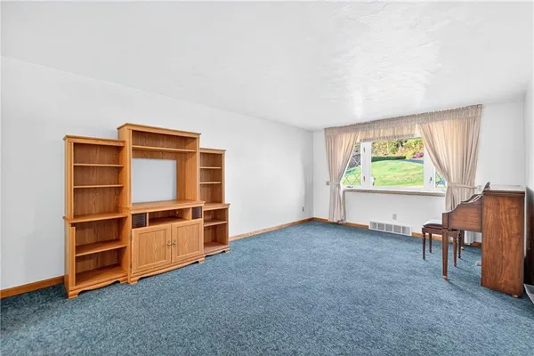 a view of room with window and furniture