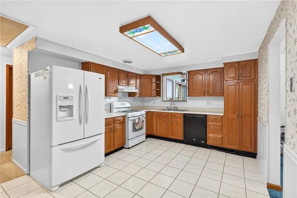 a kitchen with stainless steel appliances a refrigerator sink and cabinets