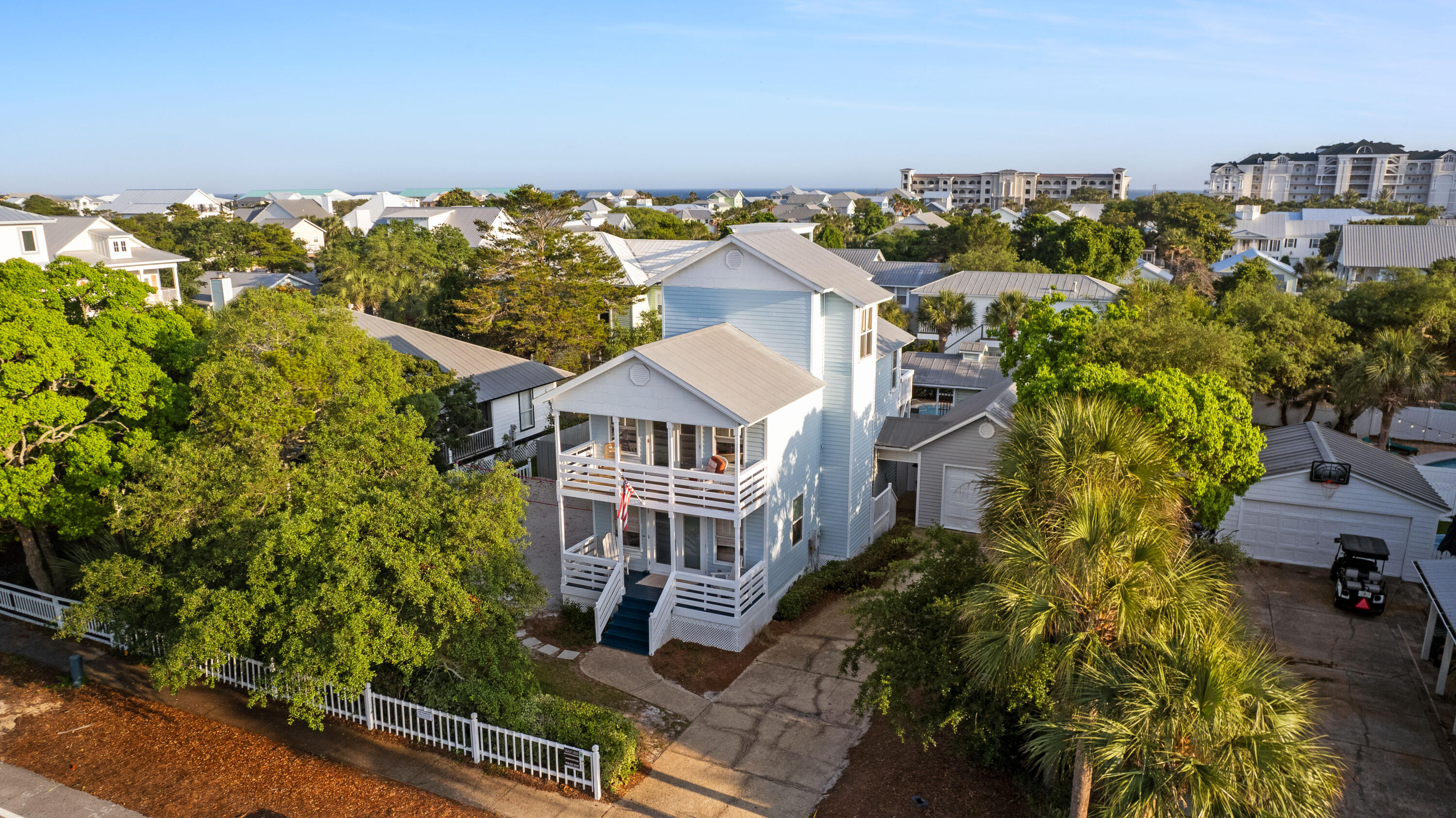 an aerial view of multiple houses with a yard