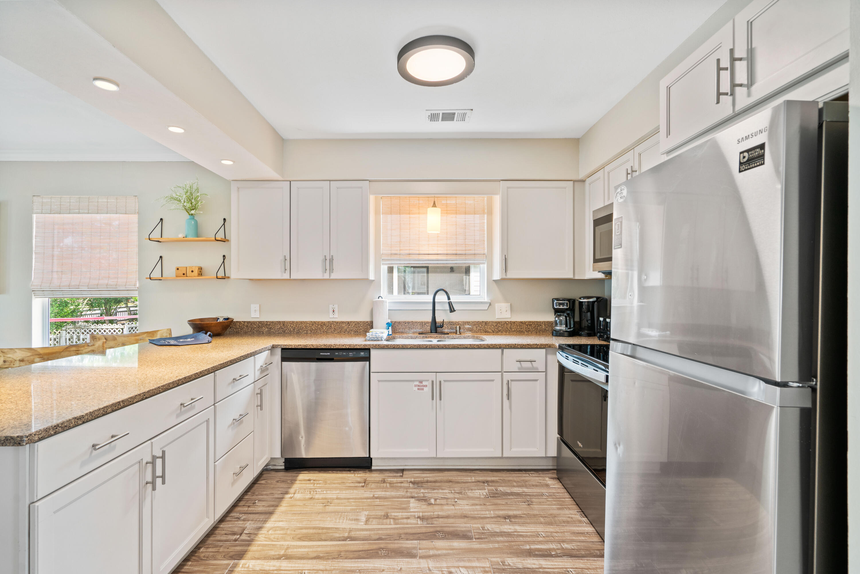4508 Luke Avenue Destin, FL 32541 - Photo 11 of 48 a kitchen with a refrigerator a sink and cabinets