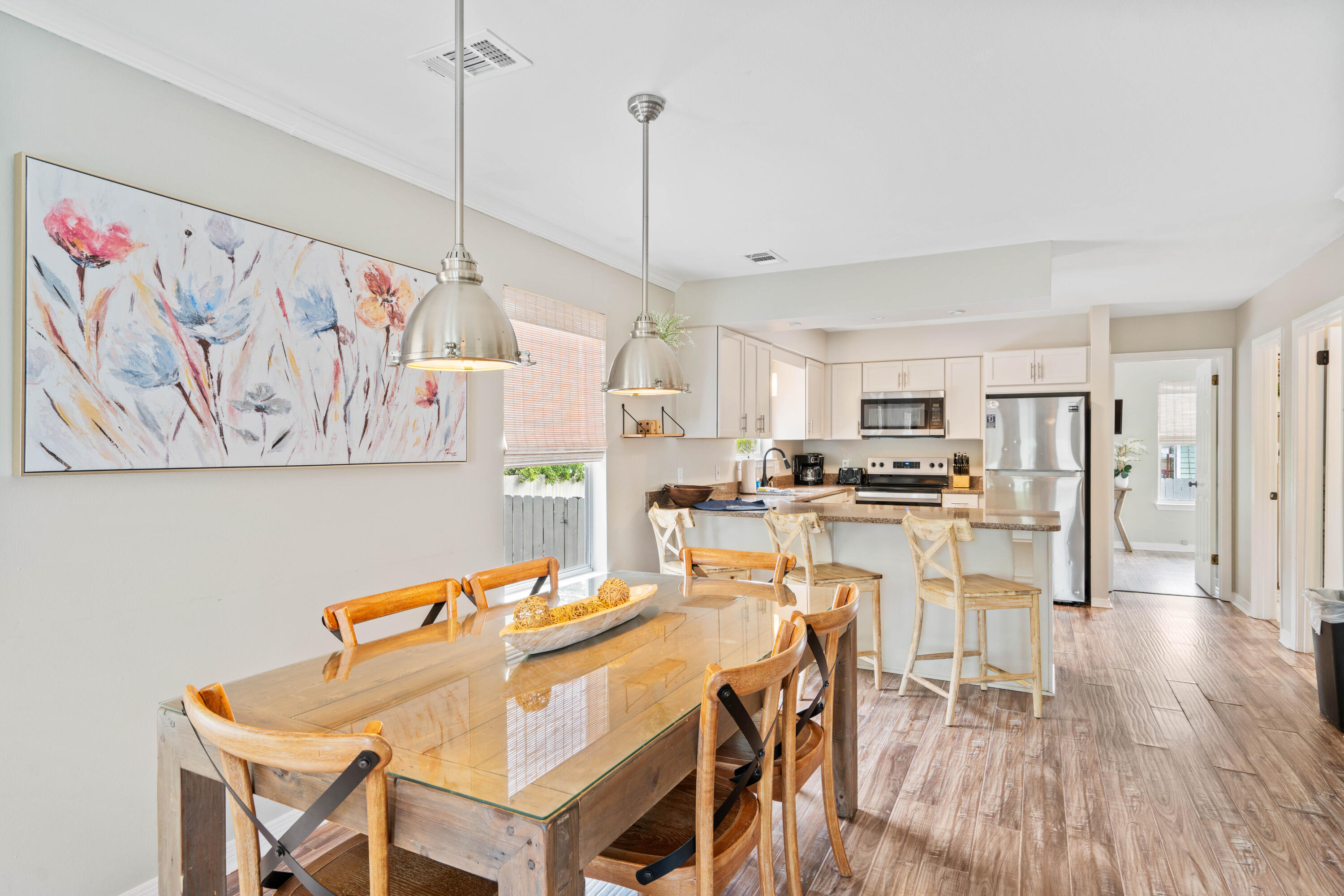 4508 Luke Avenue Destin, FL 32541 - Photo 13 of 48 a dining room with furniture and wooden floor