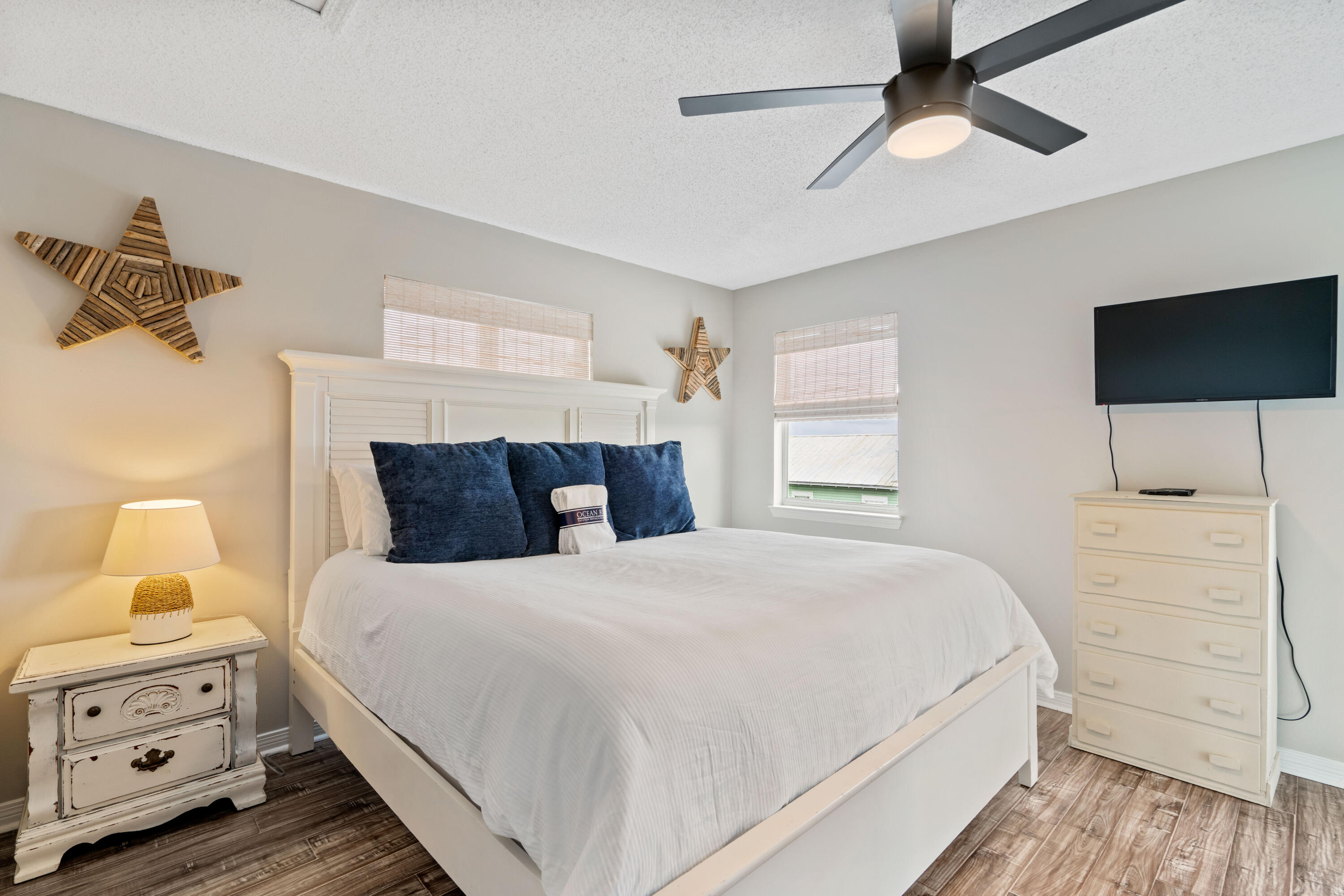 4508 Luke Avenue Destin, FL 32541 - Photo 16 of 48 a bedroom with a bed and a flat tv screen on dresser