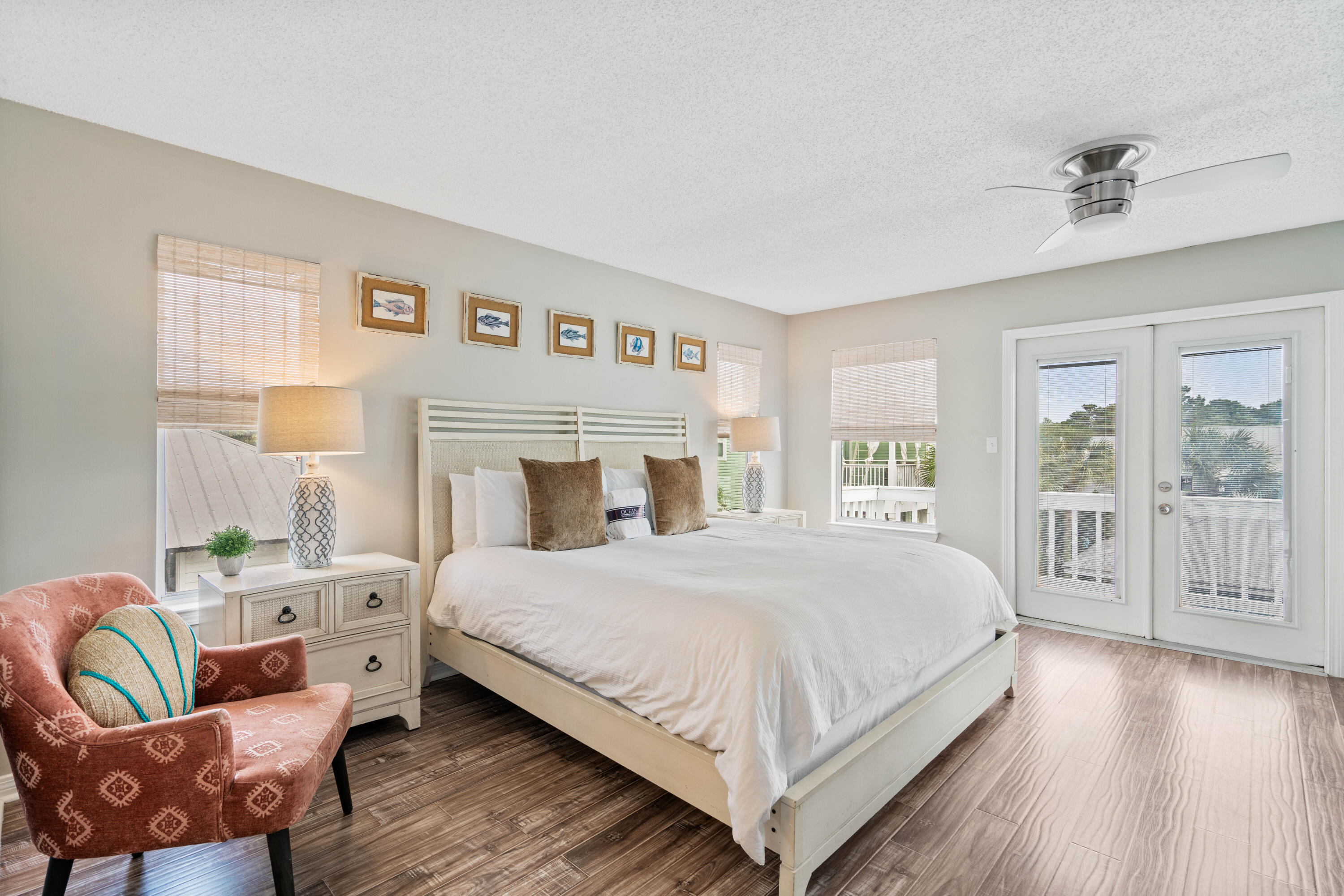 4508 Luke Avenue Destin, FL 32541 - Photo 20 of 48 a bedroom with a large bed a chandelier and windows