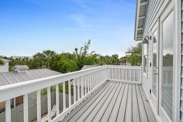 a balcony with wooden floor and fence