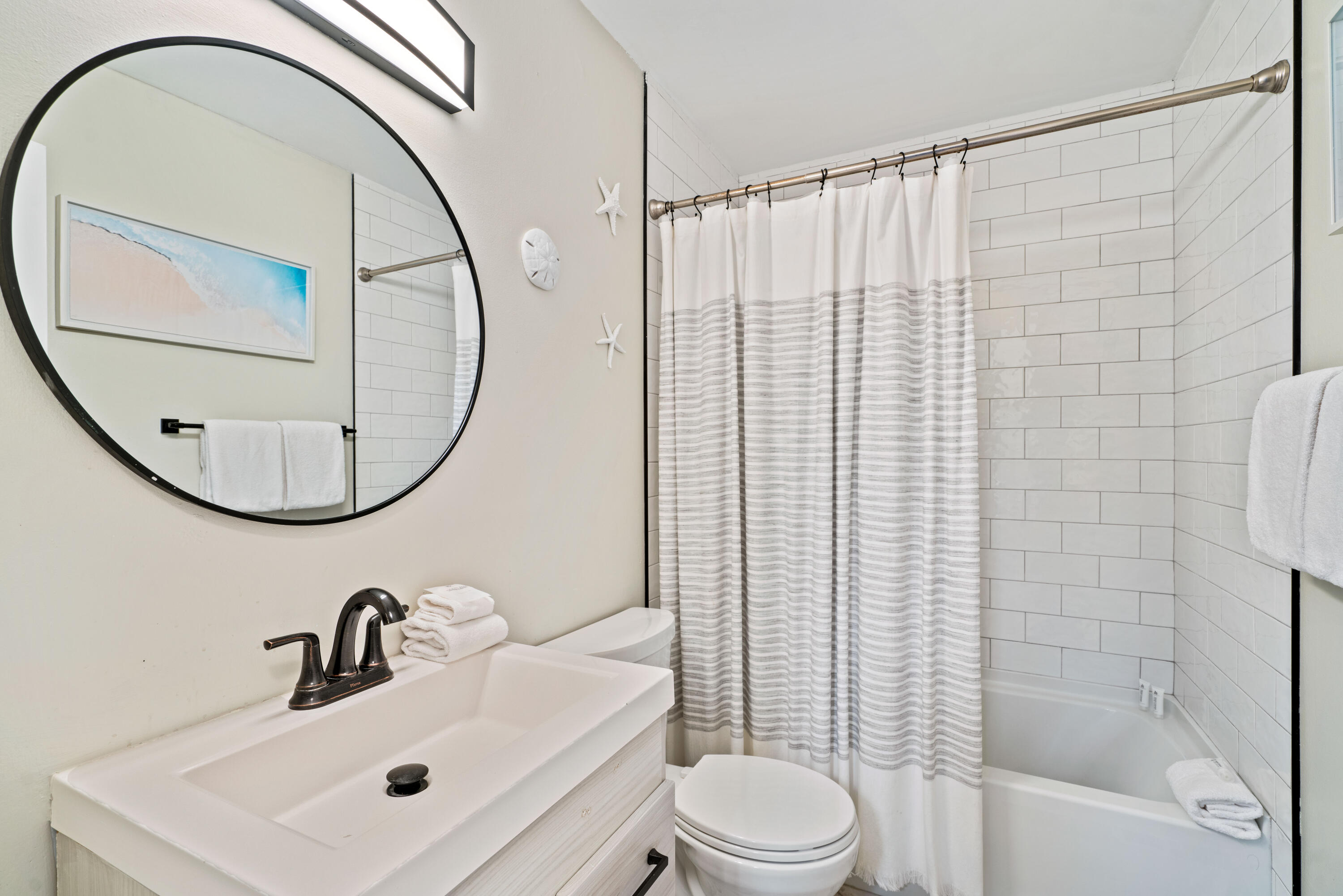 4508 Luke Avenue Destin, FL 32541 - Photo 23 of 48 a bathroom with a sink a toilet and a mirror