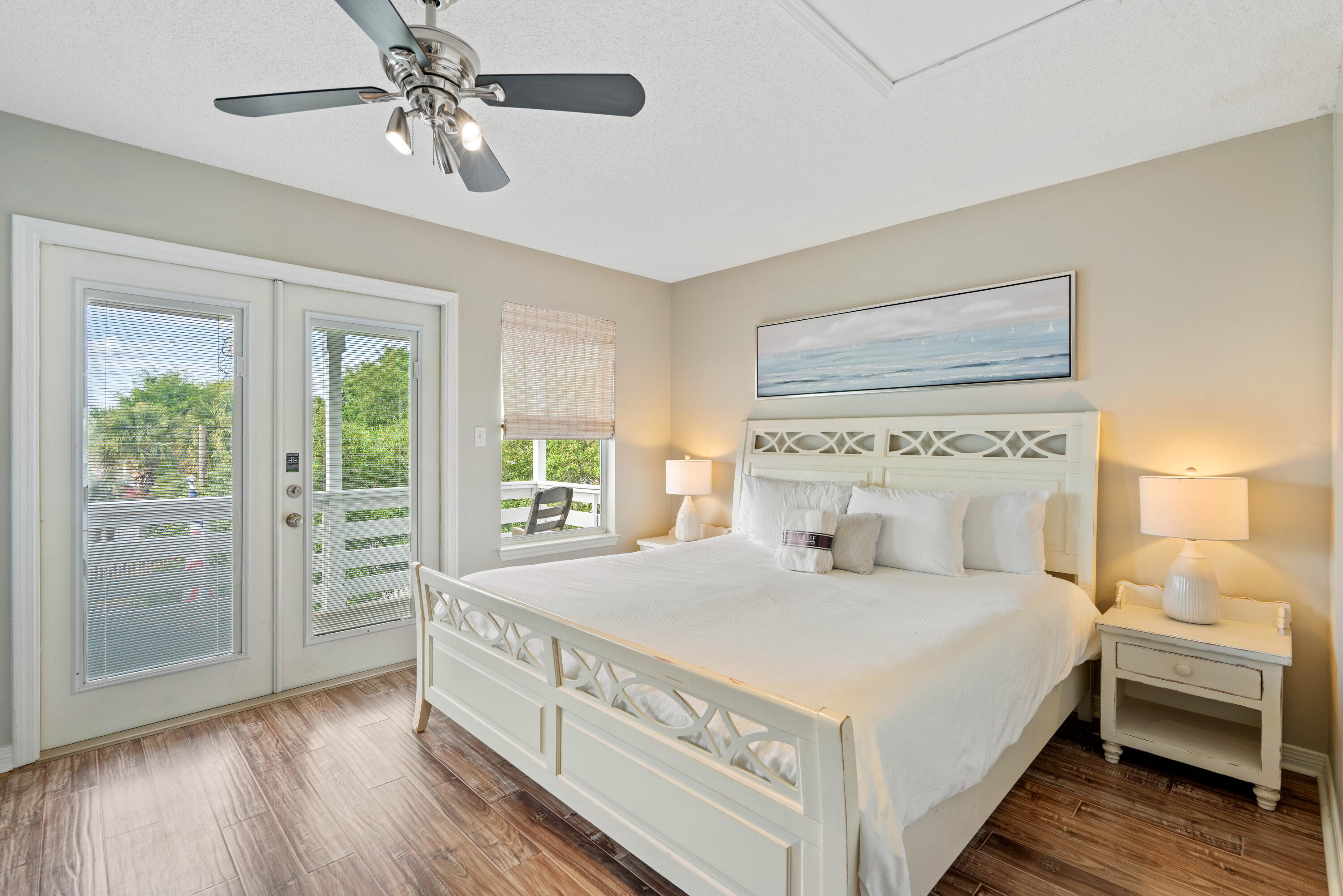 4508 Luke Avenue Destin, FL 32541 - Photo 30 of 48 a bedroom with a large bed and a chandelier