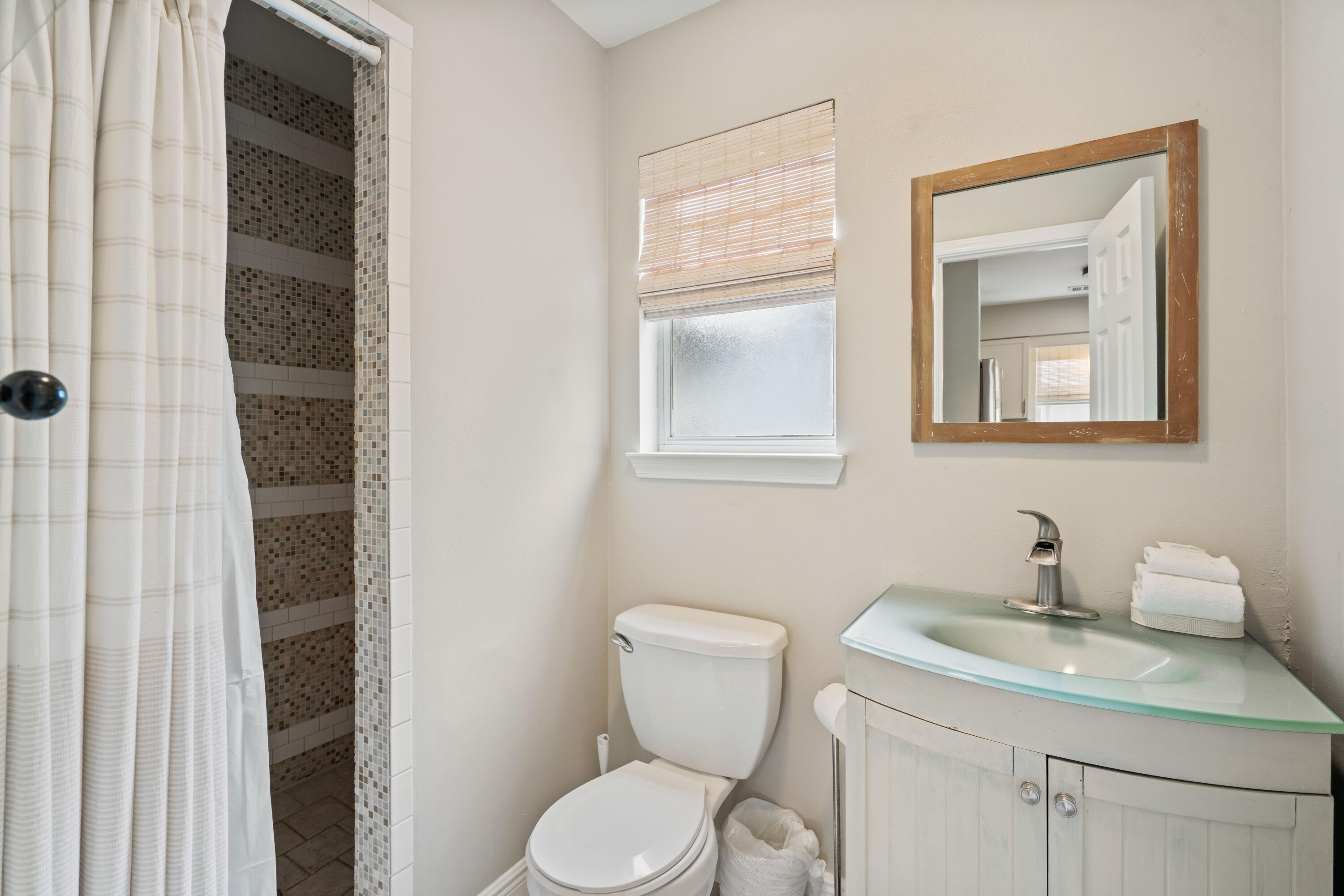 4508 Luke Avenue Destin, FL 32541 - Photo 33 of 48 a bathroom with a toilet sink and mirror