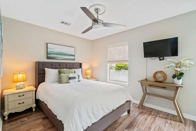 a bedroom with a bed and a flat screen tv