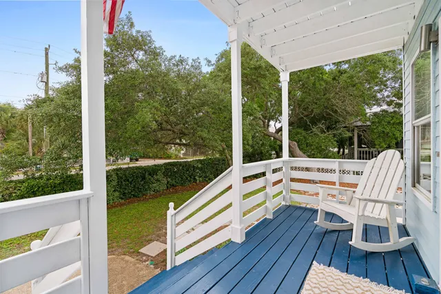 a view of balcony with wooden floor and outdoor seating