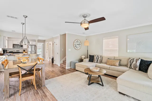 a living room with furniture and kitchen view