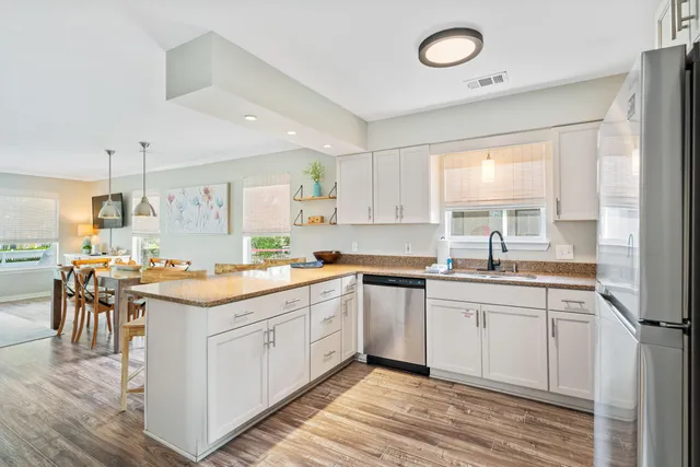 a kitchen with a sink stove and cabinets