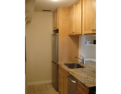 302 Commonwealth Avenue, Unit D Boston, MA 02115 - Photo 5 of 11 a bathroom with a granite countertop sink and washing machine