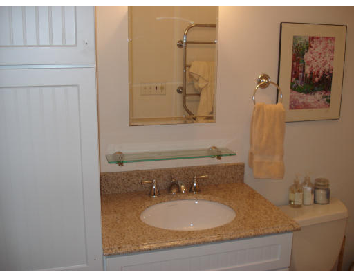 302 Commonwealth Avenue, Unit D Boston, MA 02115 - Photo 9 of 11 a bathroom with a granite countertop sink mirror and vanity