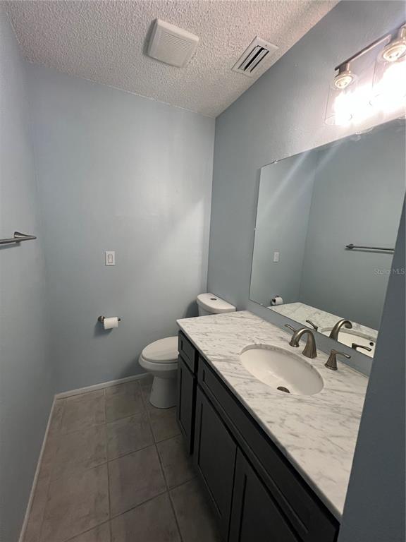 810 Kings Court, Unit D Punta Gorda, FL 33950 - Photo 10 of 10 a bathroom with a granite countertop sink a toilet and a mirror