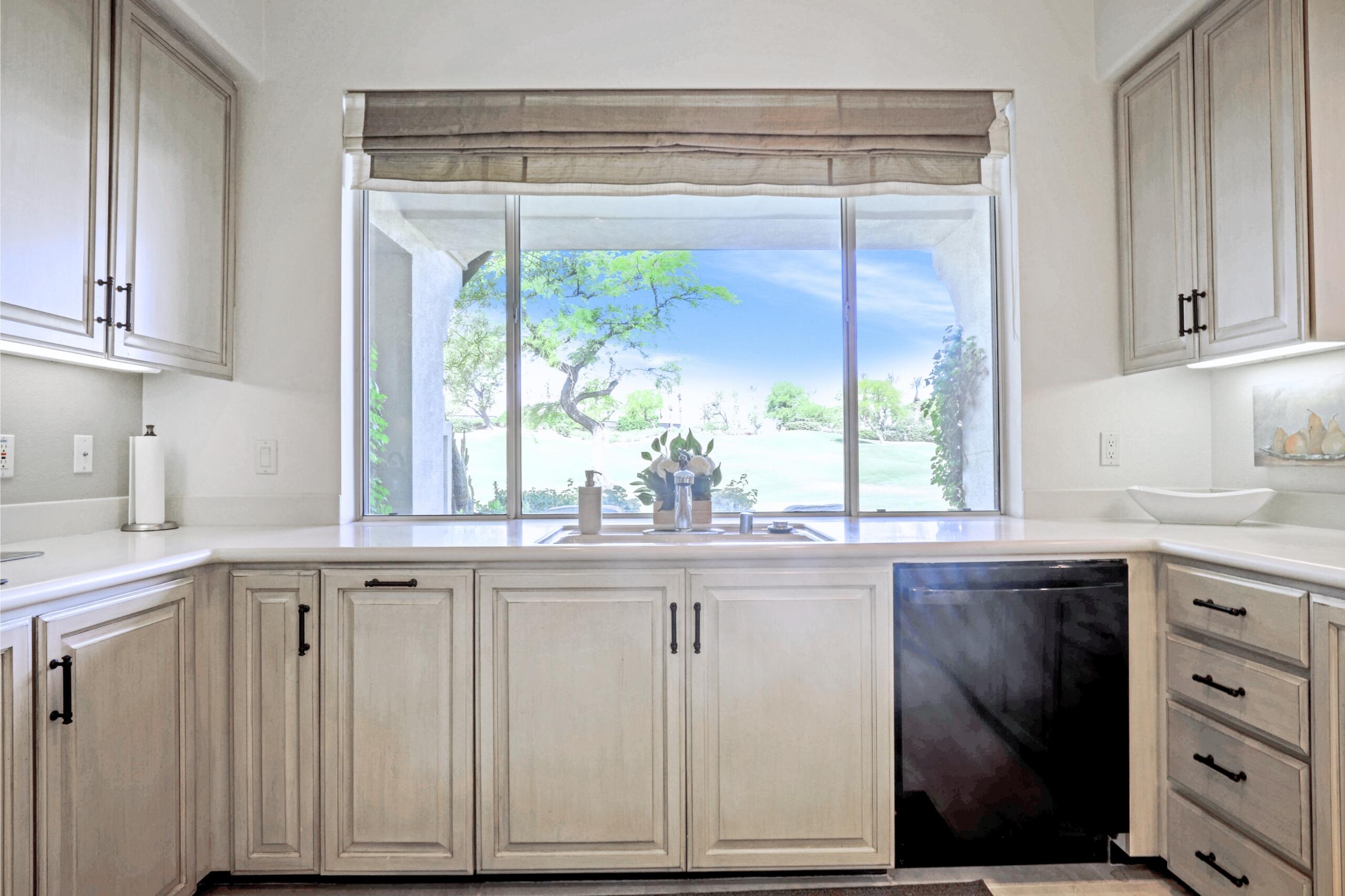 371 Indian Ridge Drive Palm Desert, CA 92211 - Photo 12 of 32 a kitchen with stainless steel appliances granite countertop a sink and a window