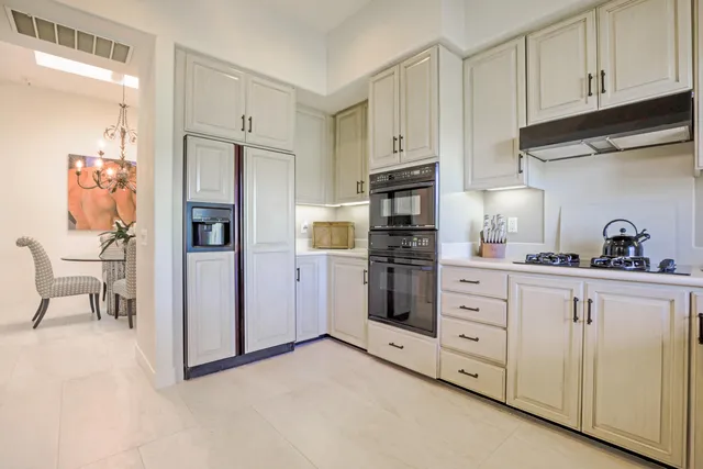 a view of a dining room with furniture and chandelier