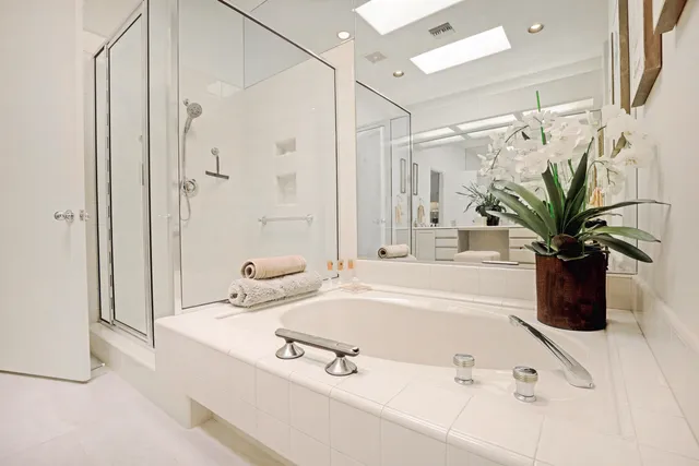 a bathroom with a sink a mirror and a shower
