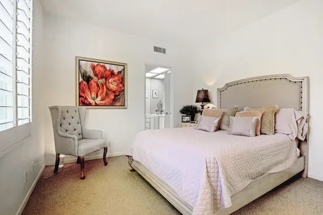 a bedroom with a bed and a cabinet