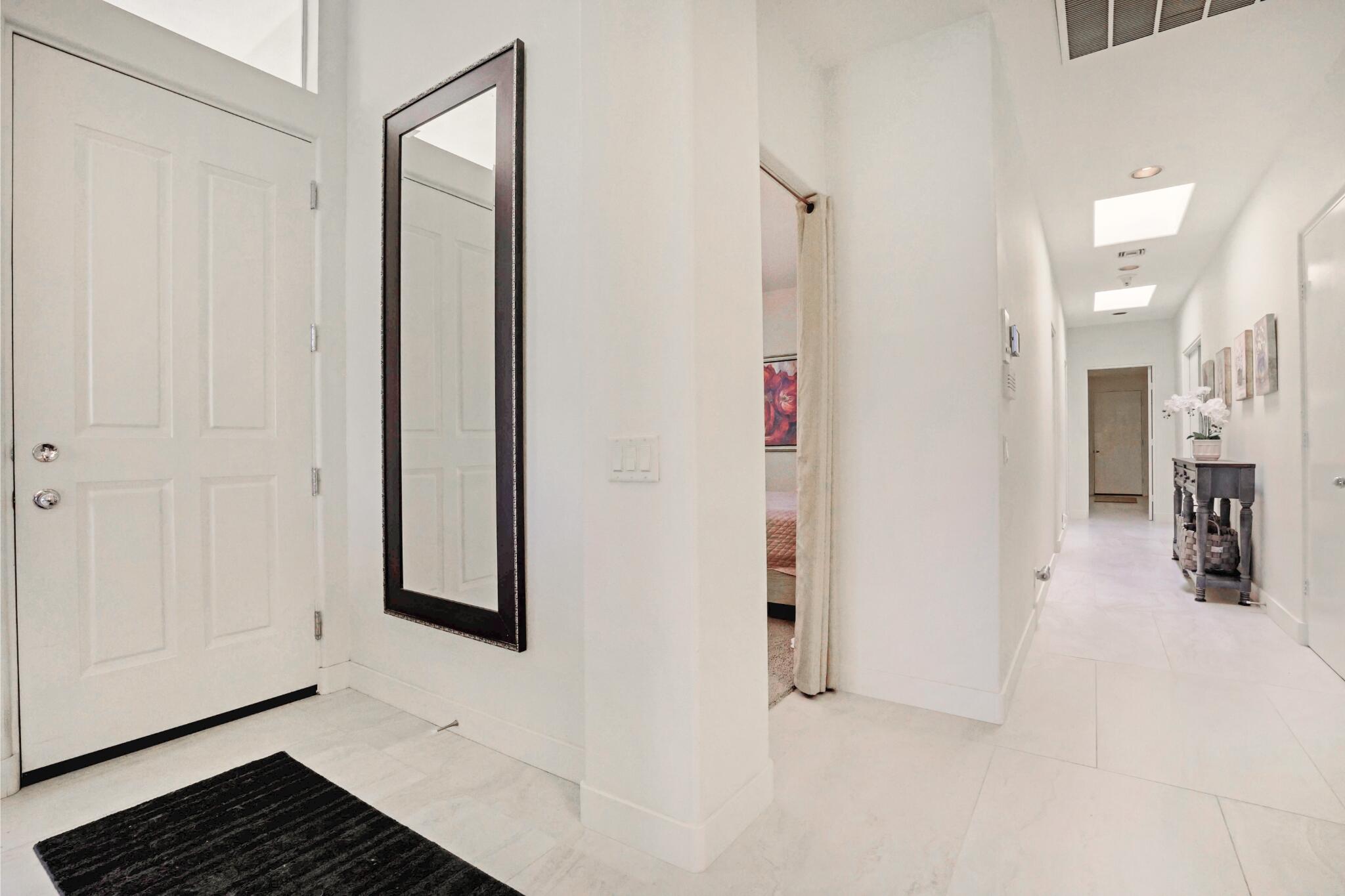 371 Indian Ridge Drive Palm Desert, CA 92211 - Photo 5 of 32 a view of a livingroom with wooden floor and a bathroom space