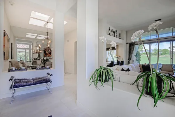 a living room with furniture a fireplace and a large window