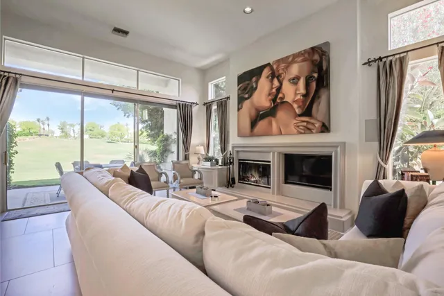 a kitchen with stainless steel appliances kitchen island granite countertop a dining table and chairs