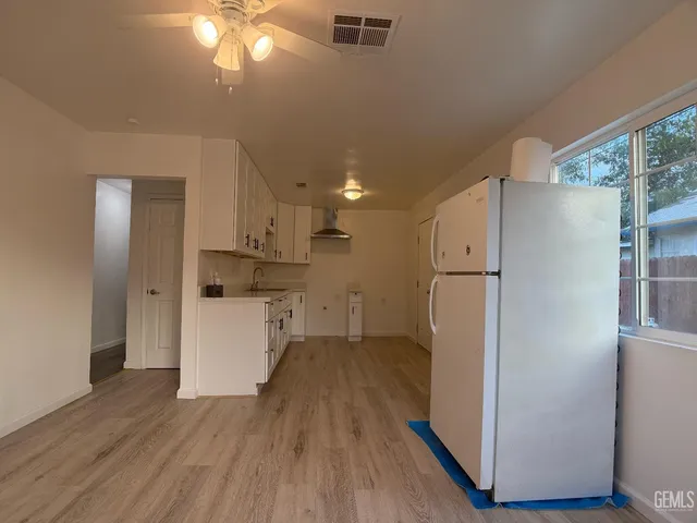 a view of kitchen and wooden floor