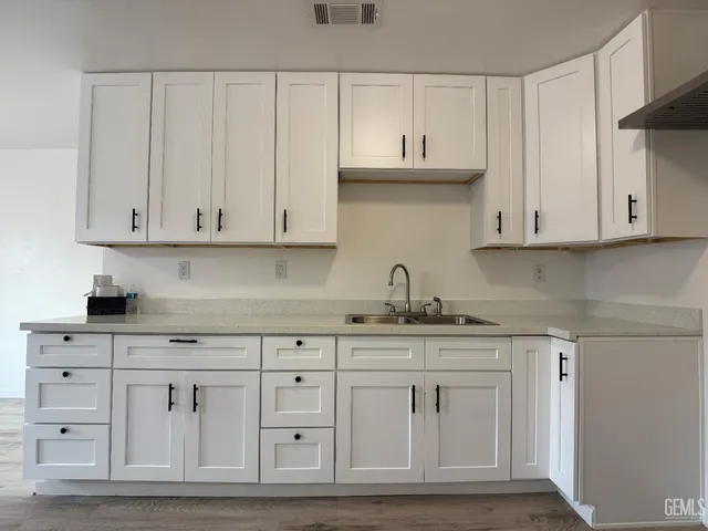 a kitchen with white cabinets