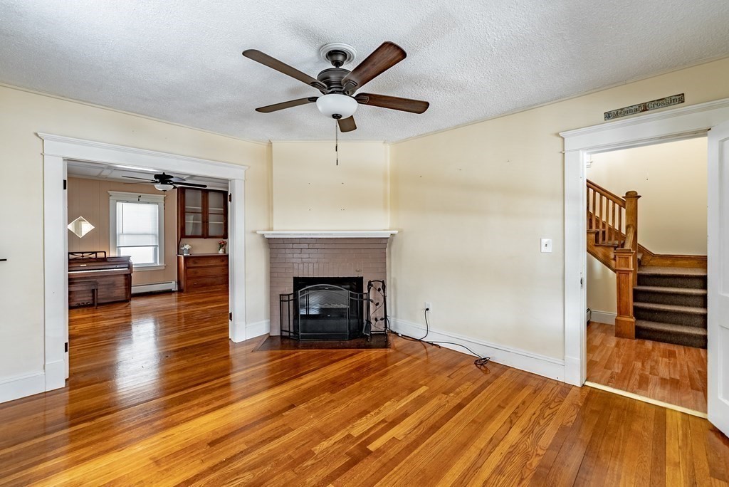 48 Rimmon Avenue Chicopee, MA 01013 - Photo 13 of 41 wooden floor in an empty room with a fireplace