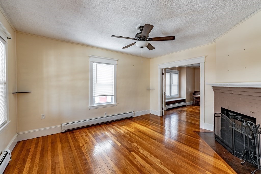 48 Rimmon Avenue Chicopee, MA 01013 - Photo 15 of 41 a view of empty room with wooden floor and fan