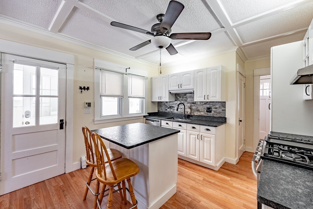 48 Rimmon Avenue Chicopee, MA 01013 - Photo 3 of 41 a kitchen with stainless steel appliances granite countertop a stove a sink dishwasher and a refrigerator with wooden floor