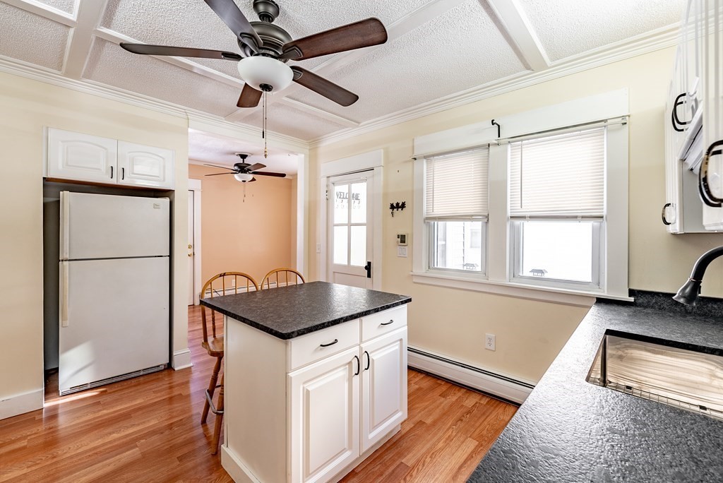 48 Rimmon Avenue Chicopee, MA 01013 - Photo 5 of 41 a kitchen with a refrigerator a sink and wooden floor