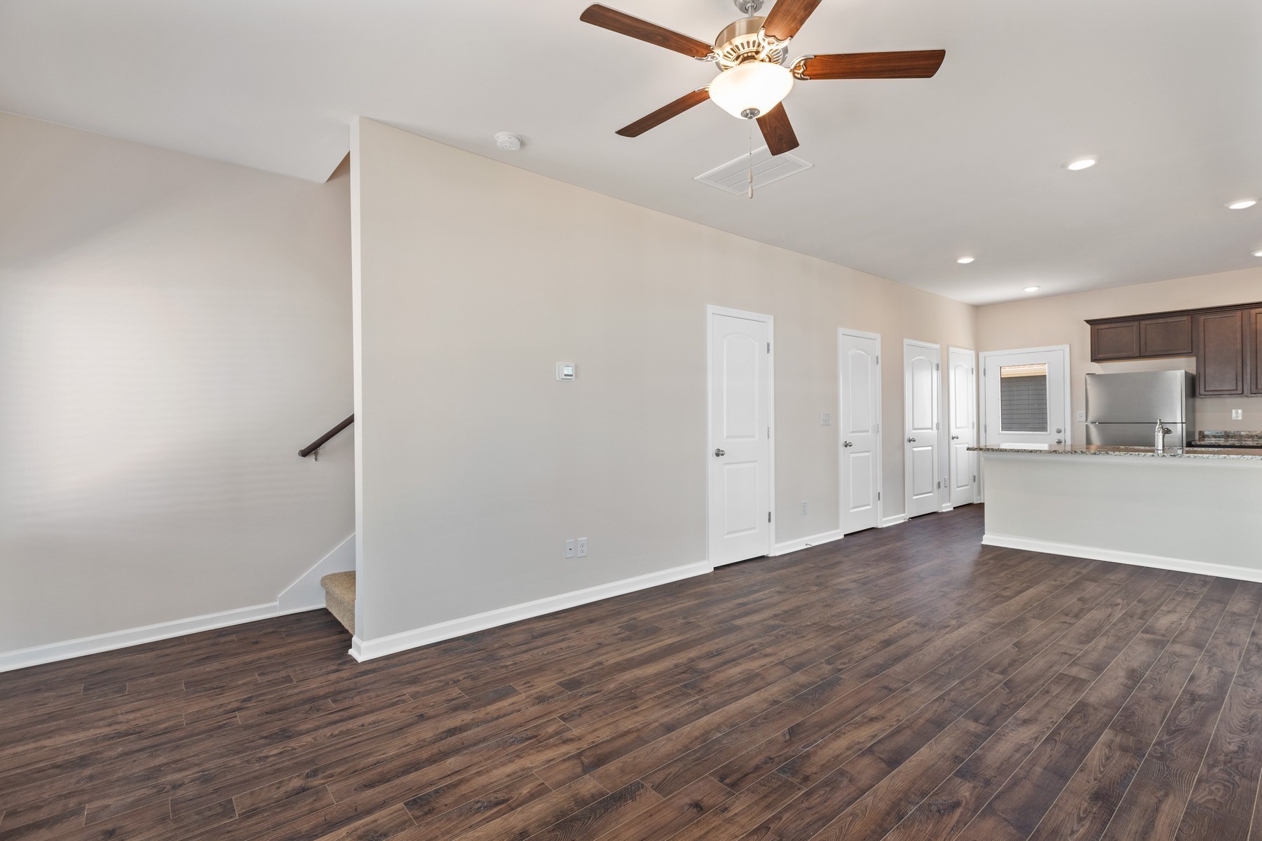 6077 Cullen Drive La Vergne, TN 37086 - Photo 2 of 7 a view of a kitchen with wooden floor and a ceiling fan