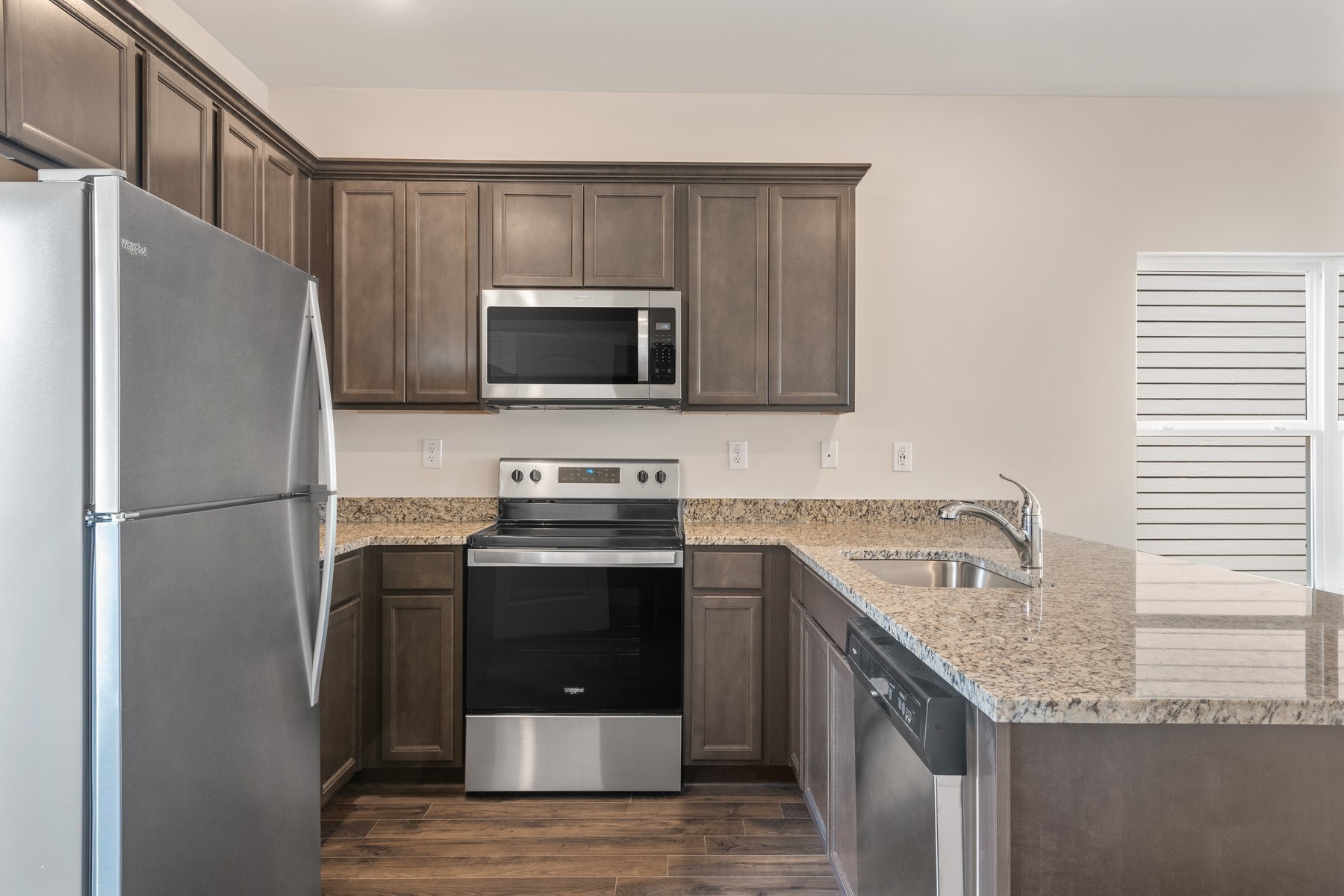 6077 Cullen Drive La Vergne, TN 37086 - Photo 4 of 7 a kitchen with stainless steel appliances granite countertop a refrigerator stove and microwave