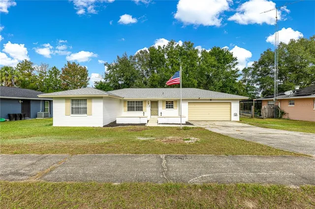 a front view of house with yard and green space